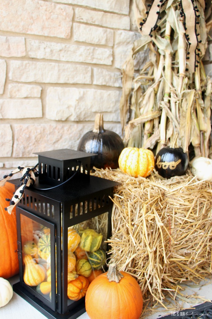 Fall Front porch with yellow orange black white and gold - lanterns filled with gourds and pumpkins for Fall - This is our Bliss