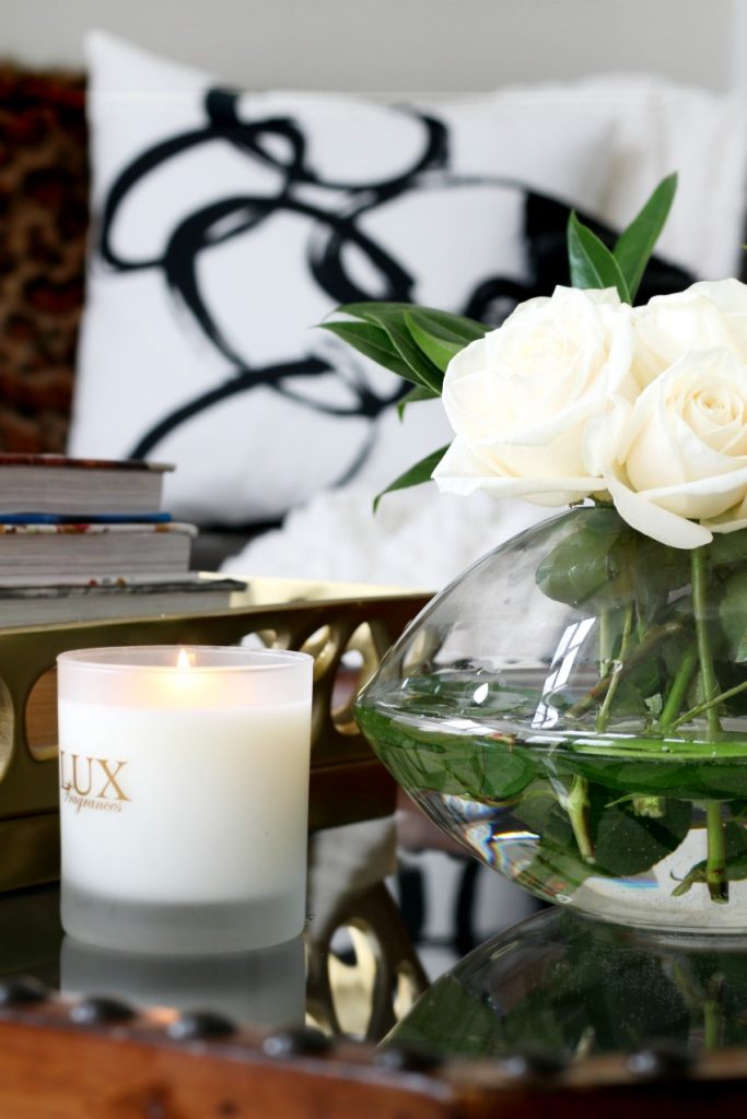 styling a coffee table with flowers and a candle - This is our Bliss