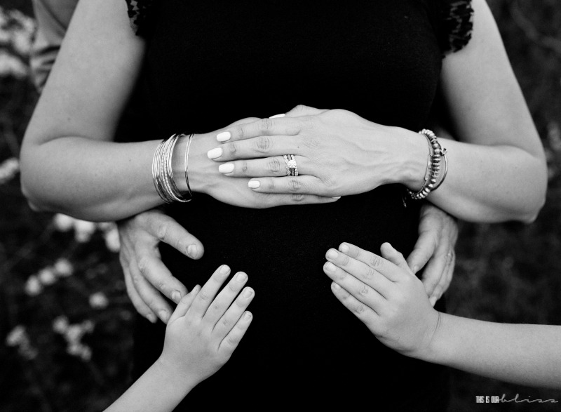 33 Week bumpdate - black and white family hands on baby bump - This is our Bliss