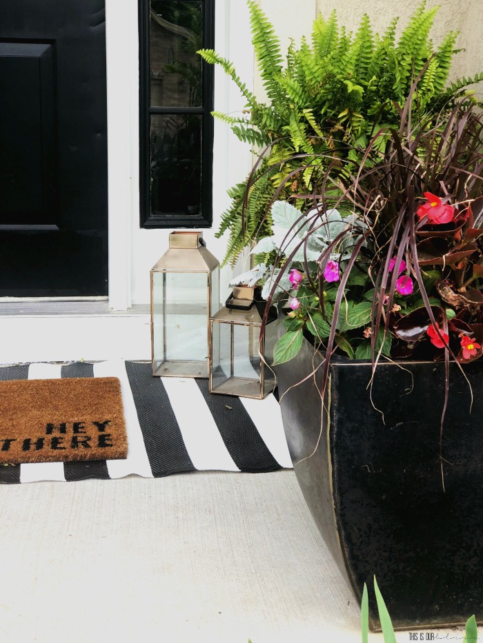 Front porch planters and Hey there rug layered over striped rug - This is our Bliss
