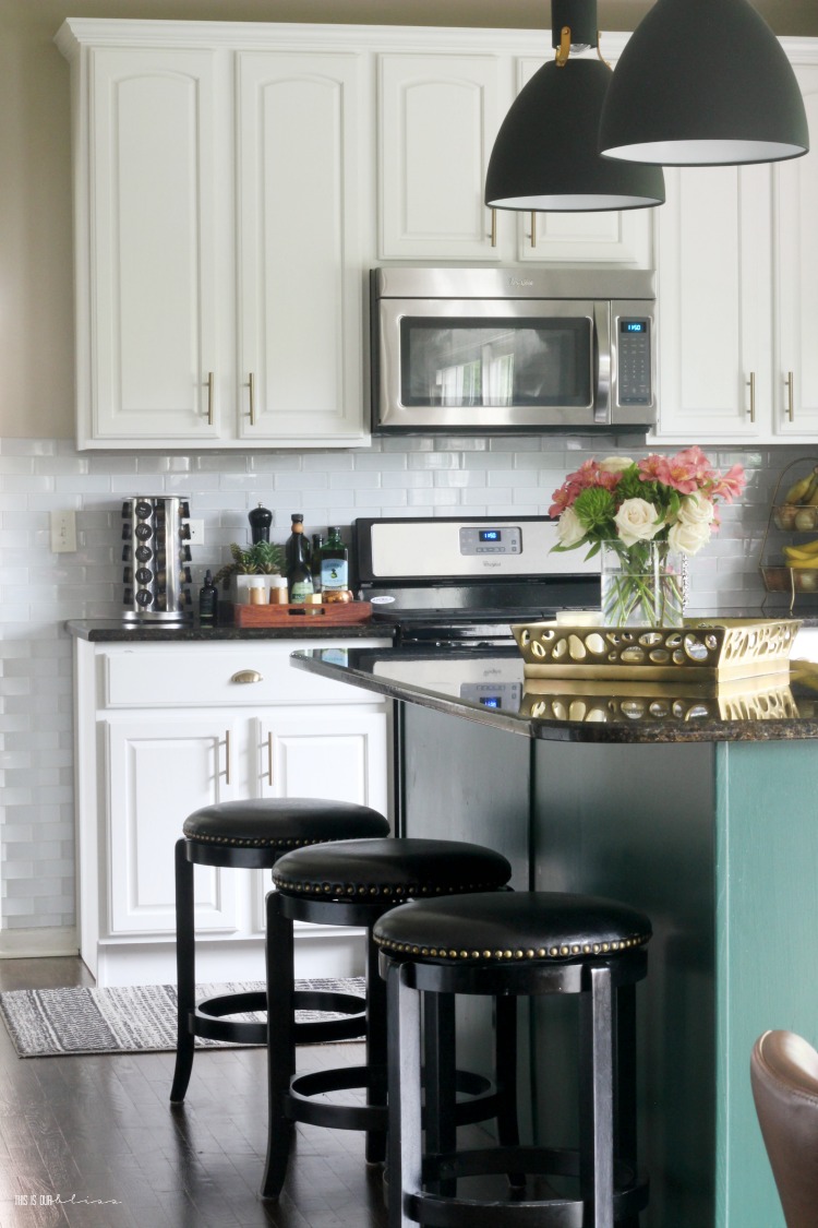 Neutral Summer decorating with a touch of pink in the kitchen - green kitchen cabinets - green kitchen island - This is our Bliss