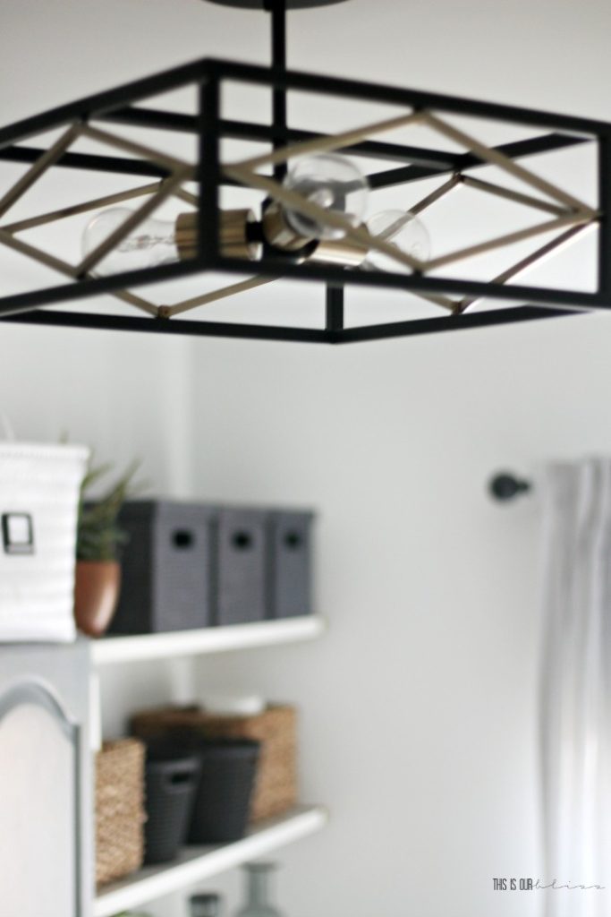 an organized and chic, small laundry Room update - black and gold semi-flush mount light in laundry room - This is our Bliss