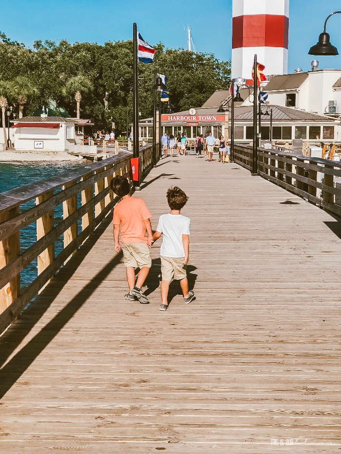 boys walking on the dock in Harbour Town by the lighthouse - Hilton Head Vacation Recap - This is our Bliss