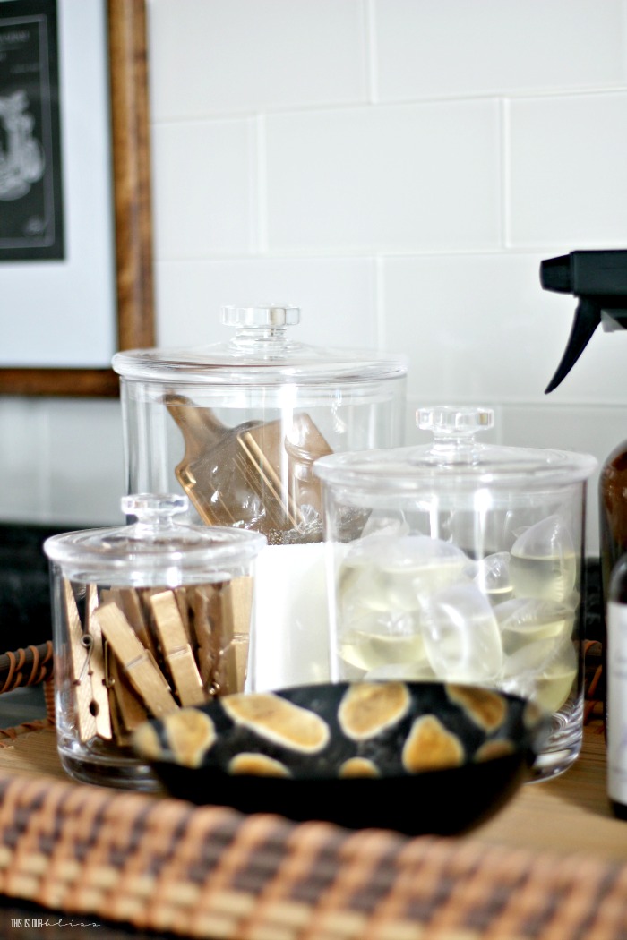 organized and chic, small laundry room makeover - canisters for laundry detergent and oxiclean - how to style items in your laundry room - This is our Bliss