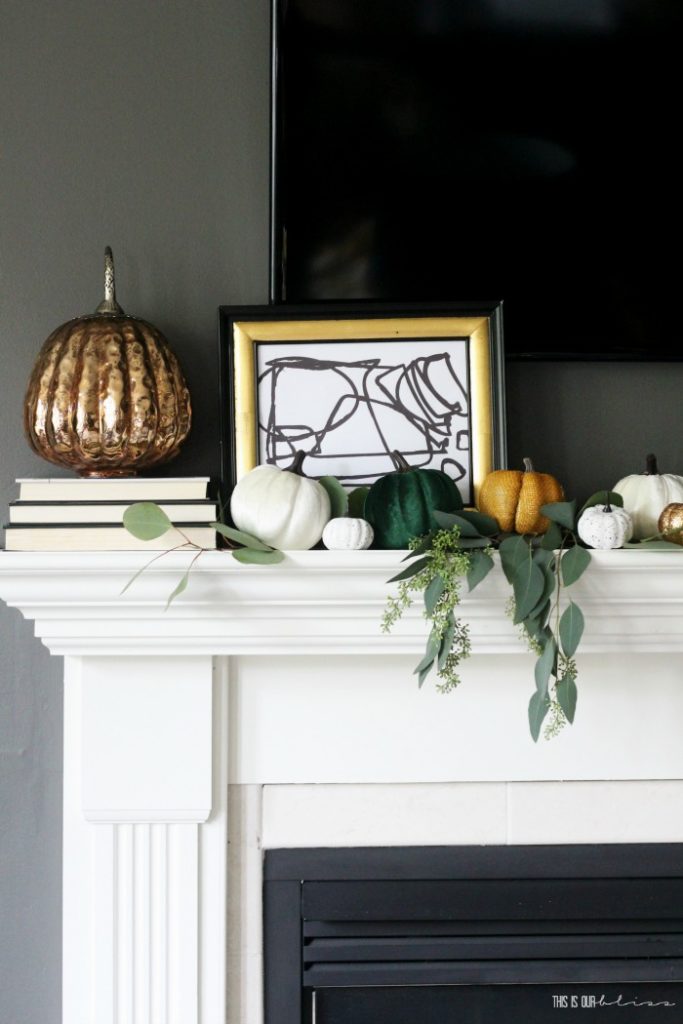 Fall mantel with pumpkins and eucalyptus stems - This is our Bliss - bold and modern mantel with black and white art print