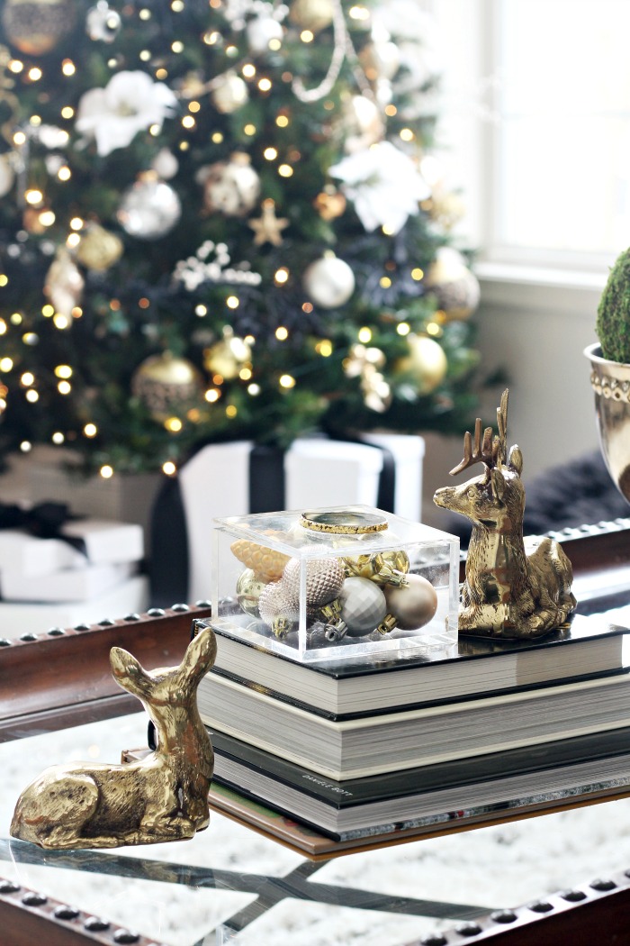 Decorating for Christmas in the Living Room - Thrifted brass deer and coffee table books with neutral Christmas tree - This is our Bliss