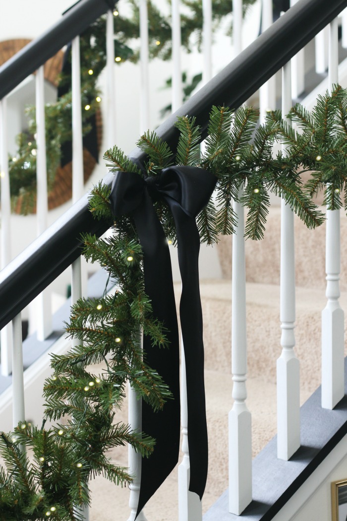 Simple Garland and black satin ribbon bows on staircase for Christmas - This is our Bliss