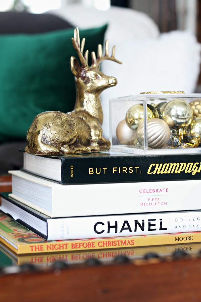 coffee table book styling for Christmas with ornaments and brass deer - This is our Bliss