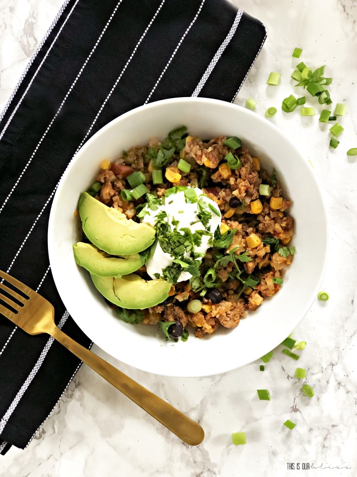 Taco Cauliflower Rice Bowls in a skillet with avocado and sour cream - My Crew Approves - This is our Bliss