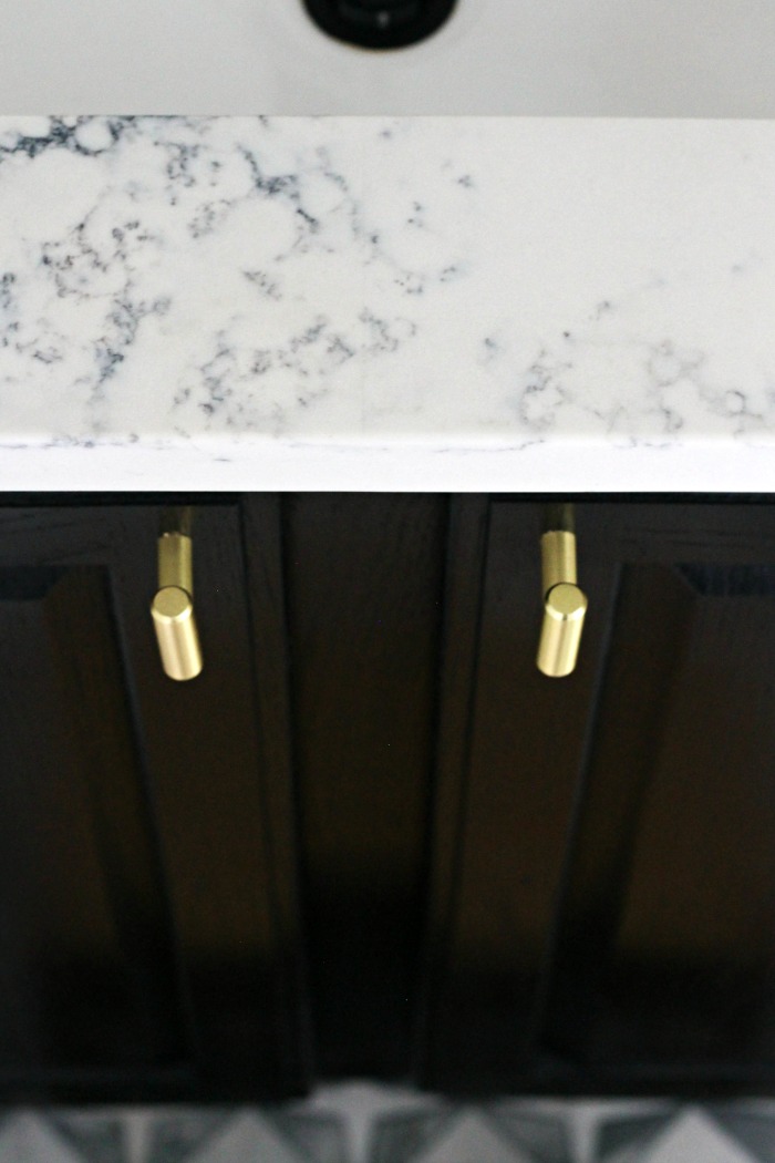 Quartz countertop black vanity brass knobs and marble tile floor - Boys Bathroom Reveal Details - This is our Bliss