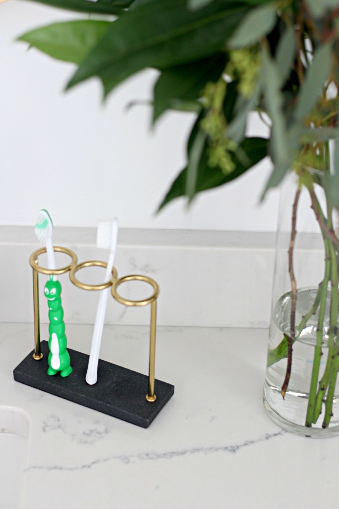 black gold toothbrush holder in boys shared bathroom - modern neutral shared boys bathroom reveal - This is our Bliss