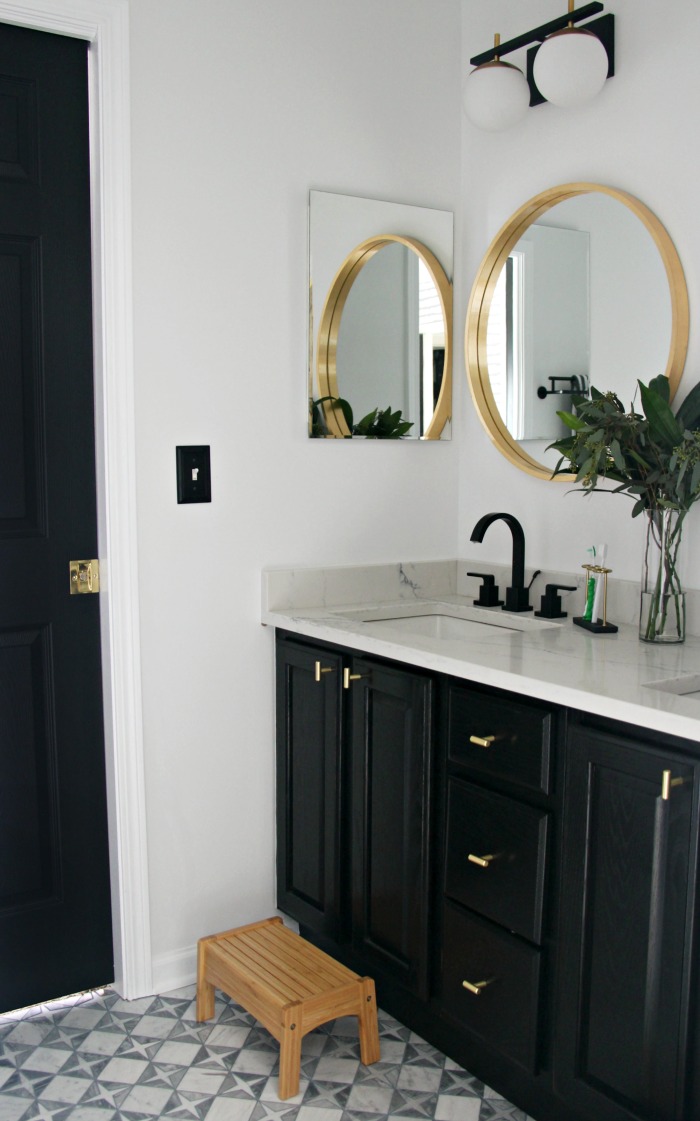 bold neutral modern boys bathroom with mosaic tile floor black vanity and black and gold touches - This is our Bliss
