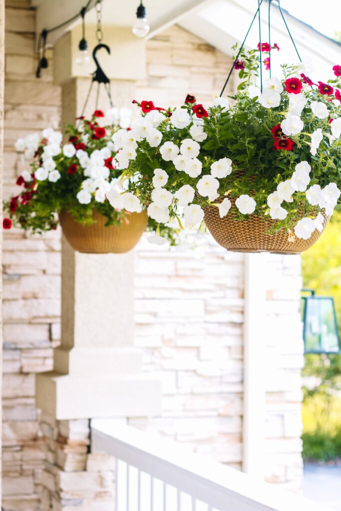 hanging baskets with red white and pink flowers - small porch decorating ideas - This is our Bliss