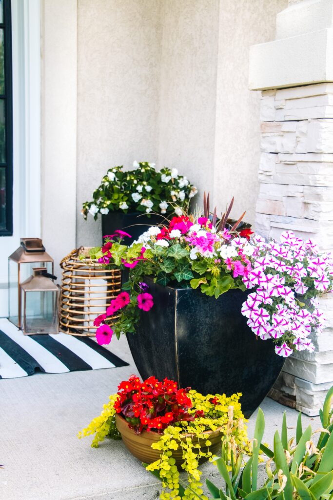 layered planters and groupings of lanterns on the porch for Summer - This is our Bliss