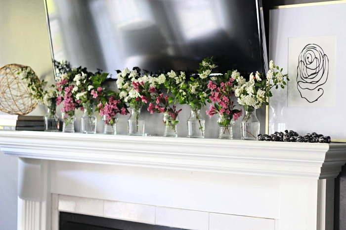 mini vases on mantel with fresh flowers - This is our Bliss