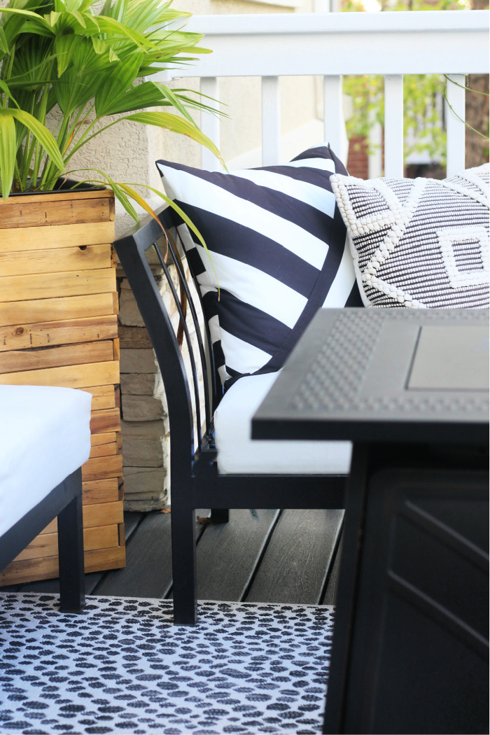 black and white deck with wood planters and firepit table - This is our Bliss