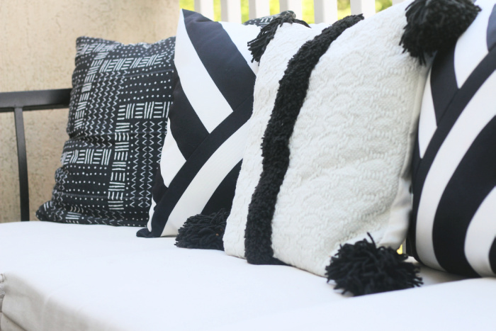 black and white textured throw pillows on outdoor sectional - This is
