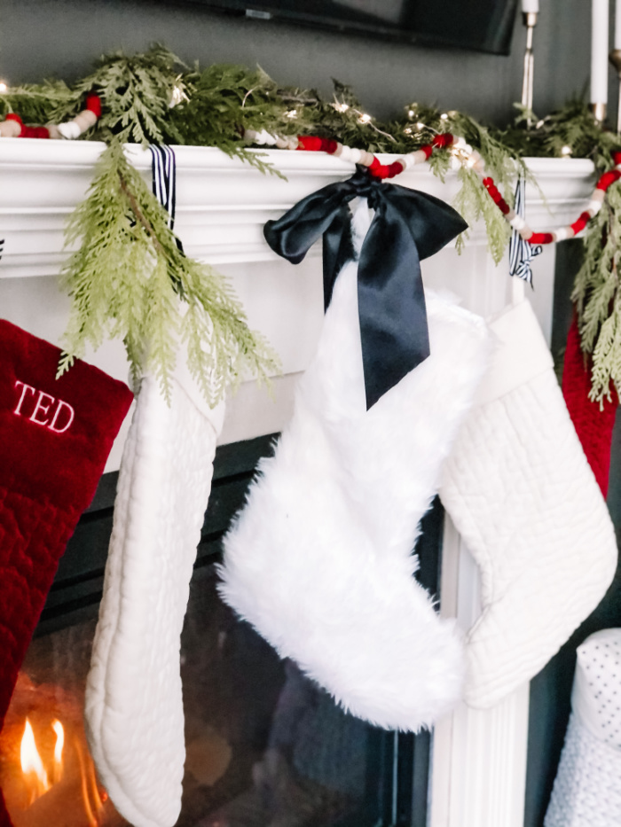 Christmas mantel with red white and gold - white furry stockings