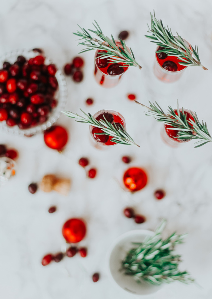 Christmas morning mimosas - Cranberry Mimosas with frozen cranberries and fresh Rosemary - This is our Bliss #christmasmimosas #christmasmorningmimosas #holidaydrinkideas #festivemimosas