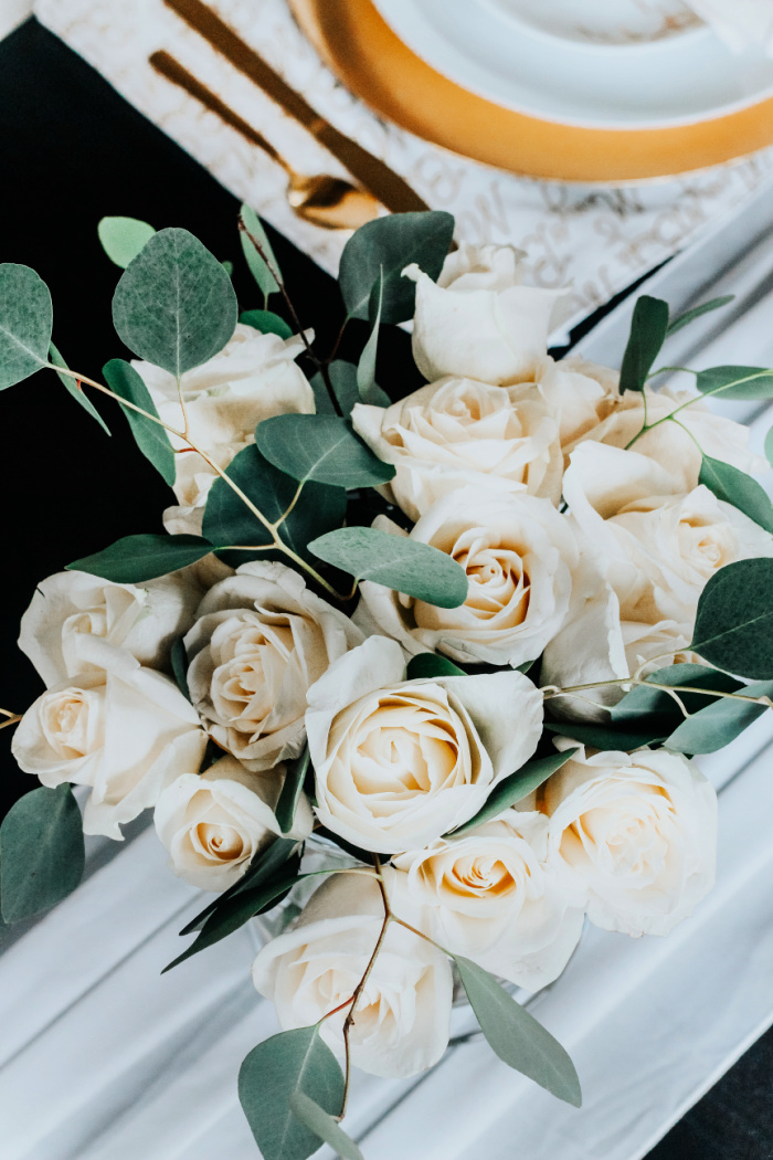 white roses and eucalyptus for dining room centerpiece - Christmas centerpiece ideas - This is our Bliss