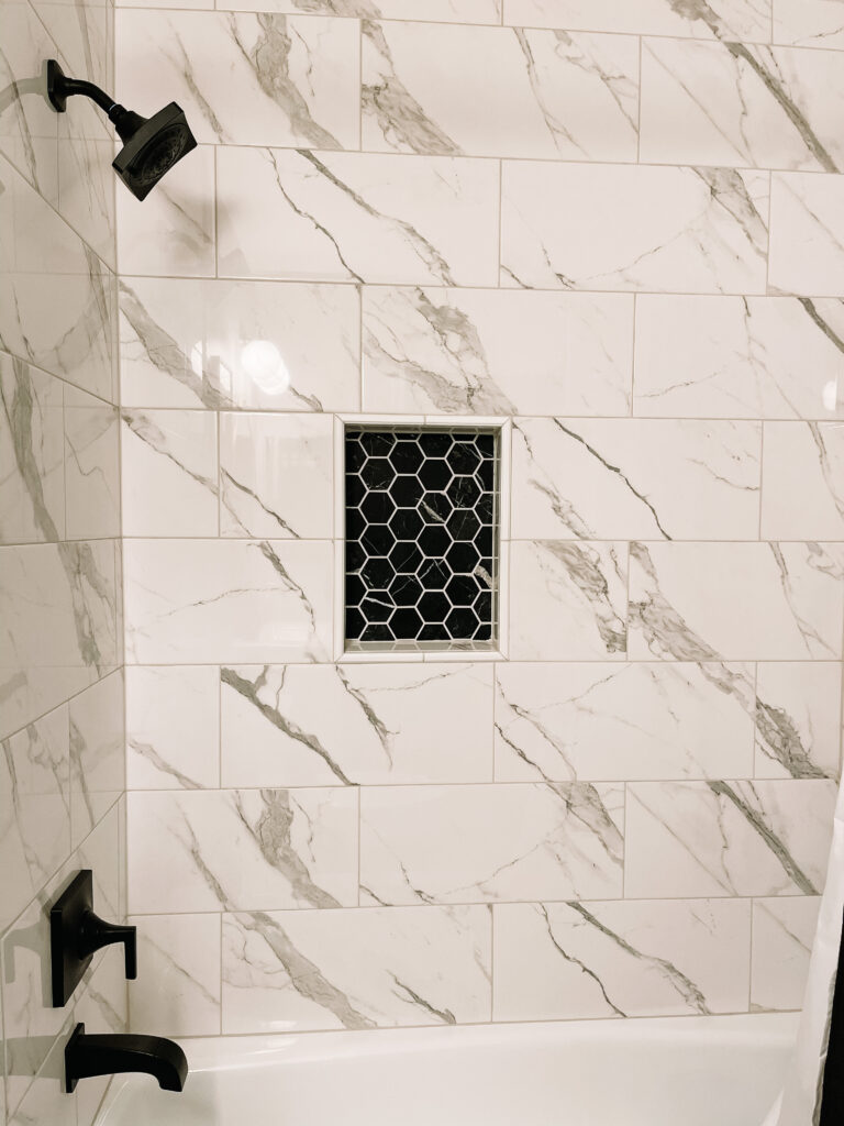 marble shower wall tile with hex tile shower niche - black white and gray boys bathroom - #smallbathroomideas #bathroomtile - This is our Bliss