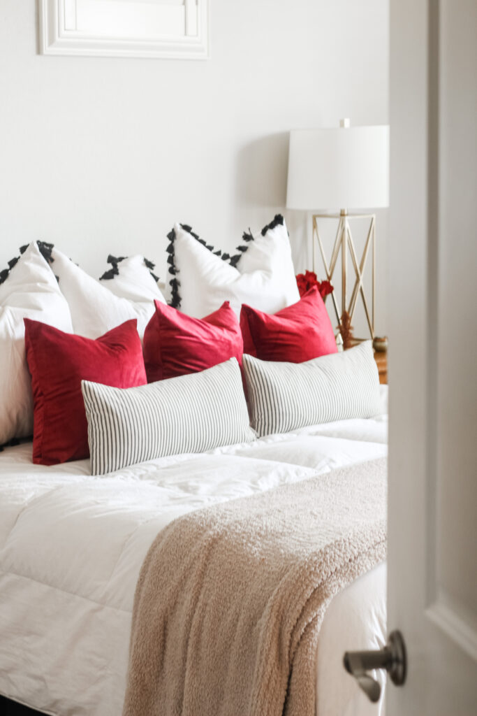 red pillow covers in the bedroom for a touch of holiday flair - This is our Bliss