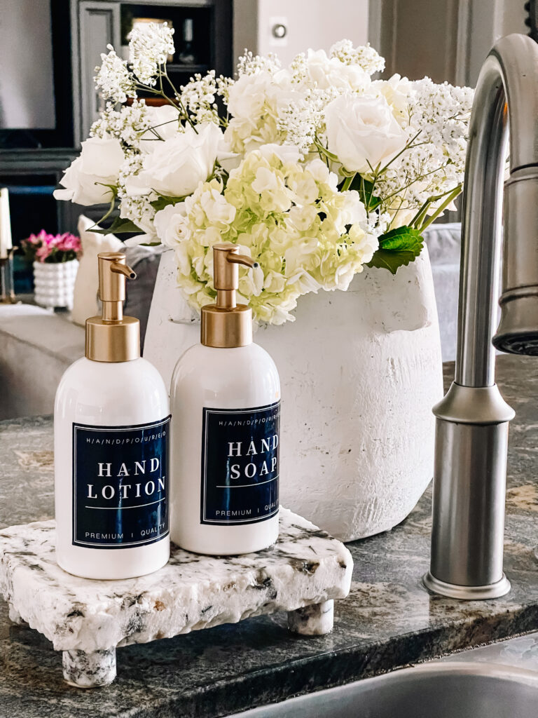 soap dispensers with labels by kitchen sink - Summer home tour - This is our Bliss 