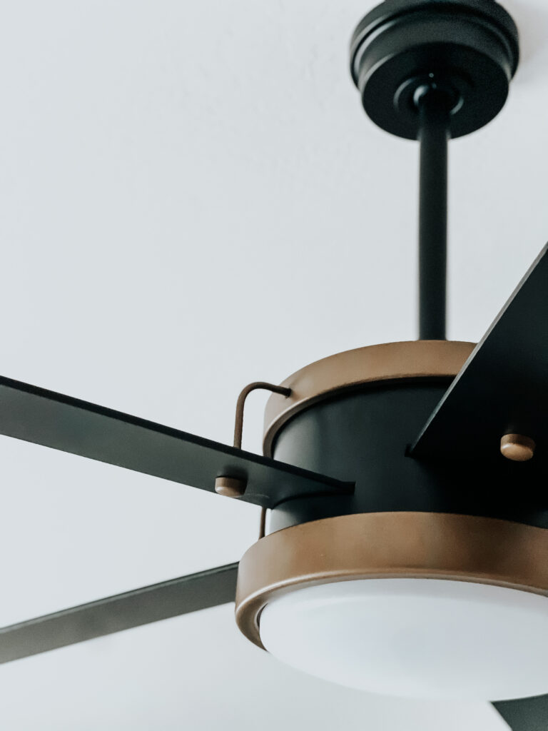 kichler satin black ceiling fan with gold detail and LED light - This is our Bliss - primary bedroom ceiling fan update