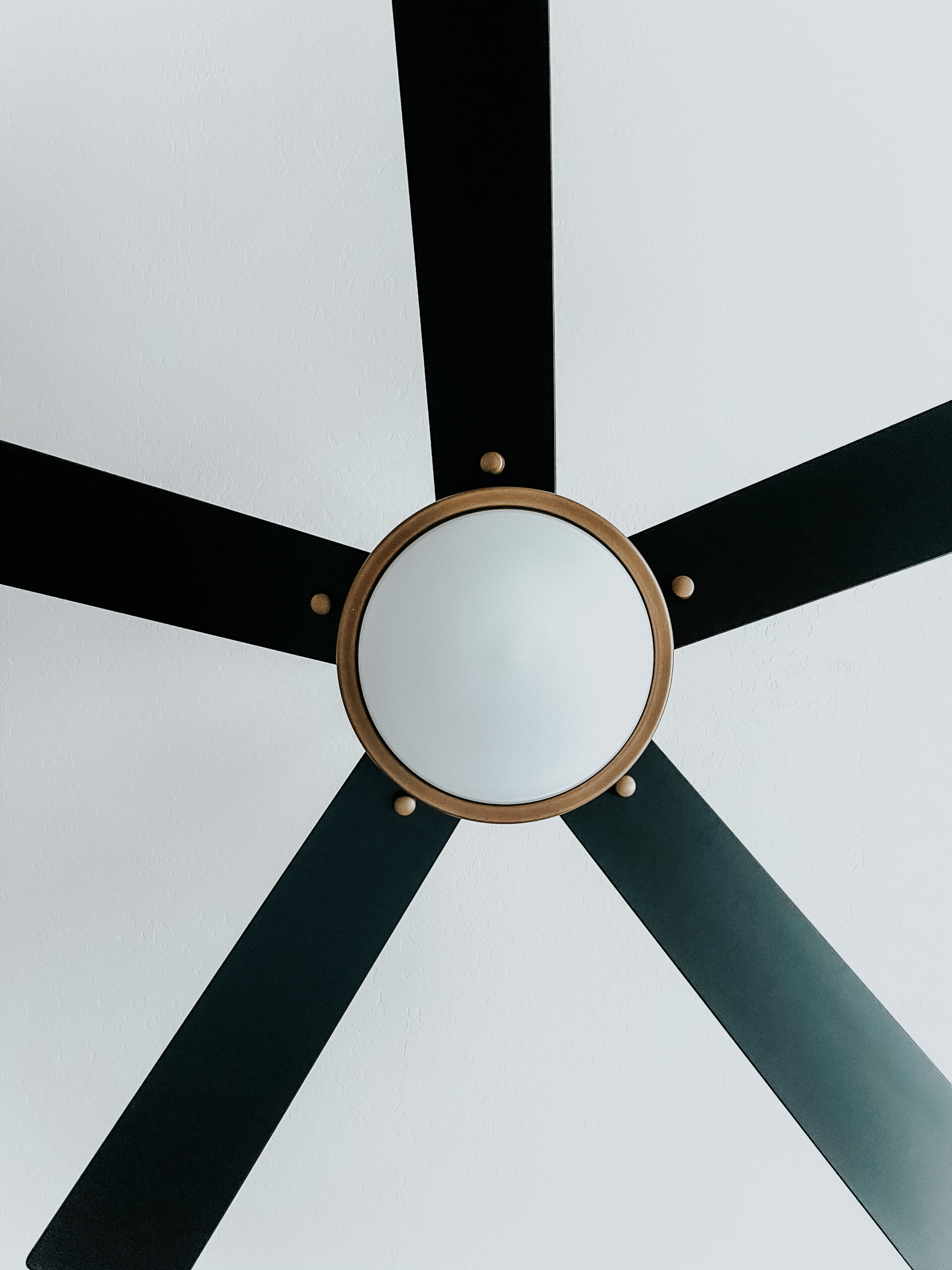 kichler satin black ceiling fan with gold detail and LED light - This is our Bliss - primary bedroom ceiling fan update