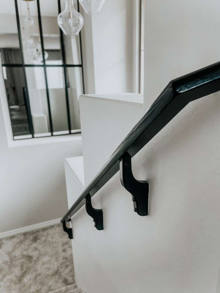 black staircase railing - painted black railing in the stairwell - This is our Bliss - Staircase makeover